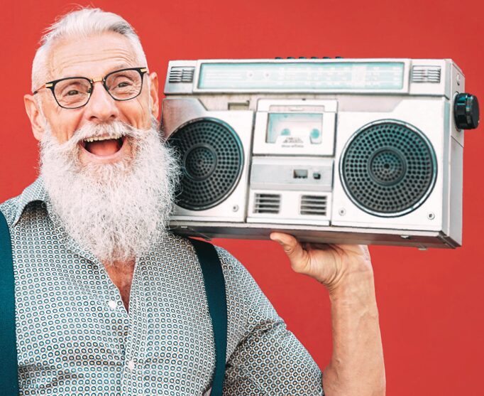 Happy and healthy older gentleman carrying a boom box