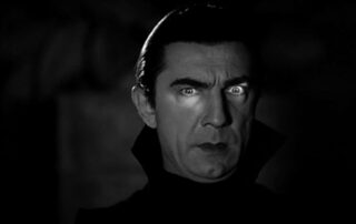 Bela Legosi as Dracula with light across his eyes. Public domain