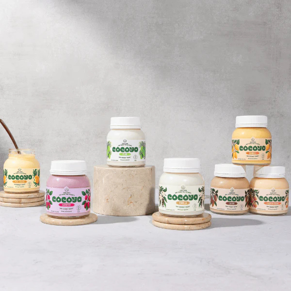 Photo of coconut yogurt jars on light gray background